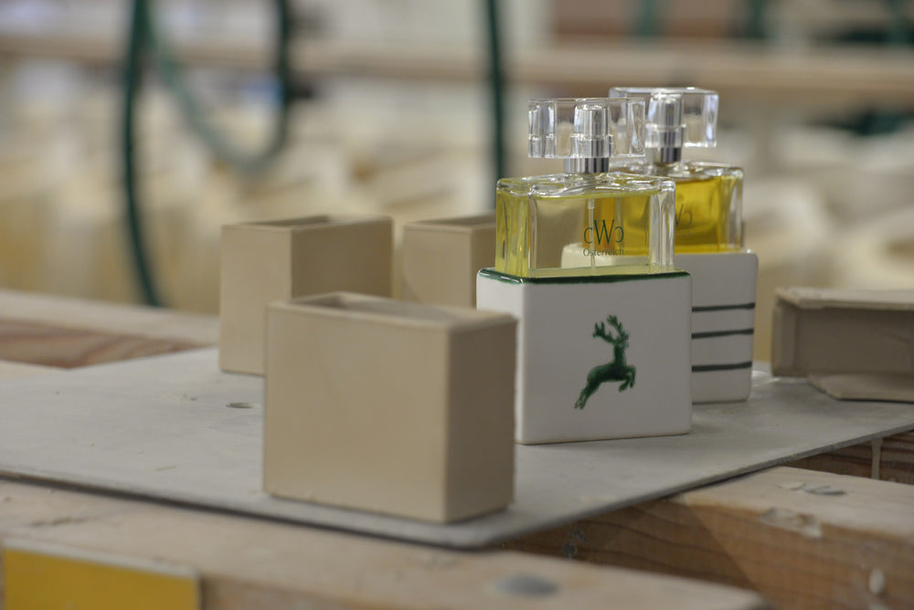 CWC GREEN STAG and GREYFLAME 75 ml in GMUNDNER Keramik beside unglazed raw pieces in the manufactory in Gmunden